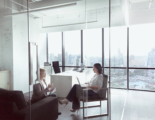 Women talking together in business office
